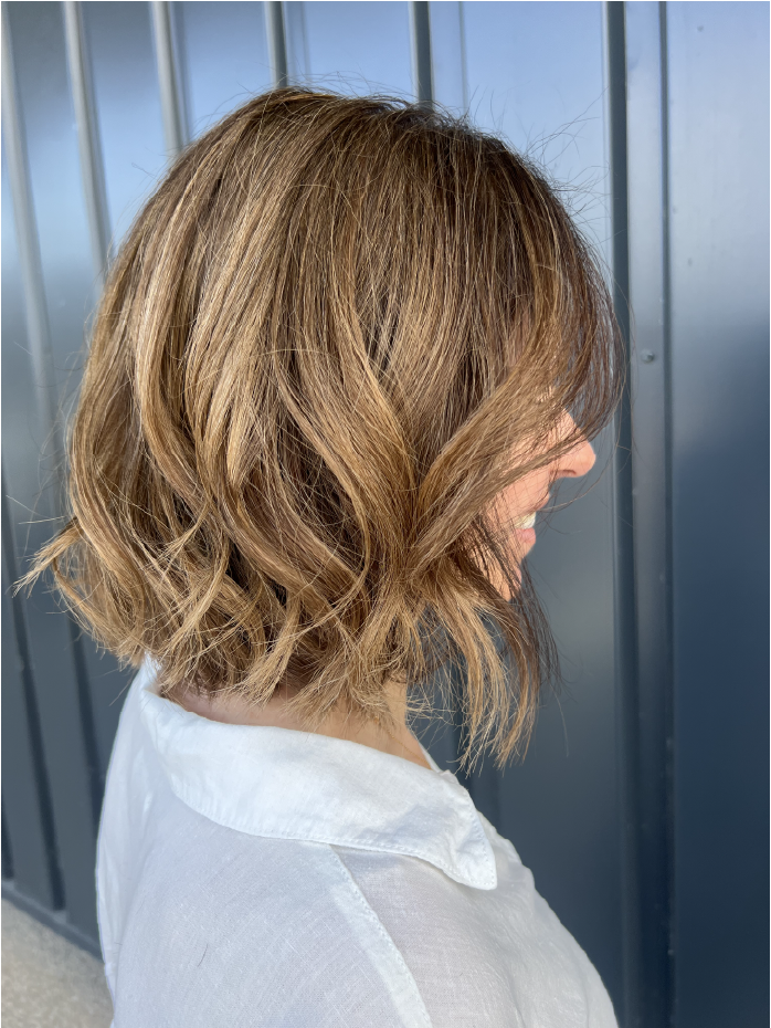 Cheveux ondulés couleur miel, balayage léger par le salon de coiffure Célia Fiorini